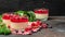 Berry dessert with cream sauce in small jars. Italian dessert. Raspberry Panna cotta with raspberry jelly on a dark background.