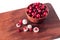 Berry dessert made from fresh tasty healthy cranberries in sugar glaze and a clay bowl.