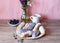 Berry glazed eclairs with blueberries on a wooden background with a decor consisting of a vase with wildflowers and a