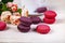 Berry macaroons. white cup and rose