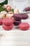 Berry macaroons. white cup and rose