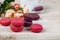 Berry macaroons. white cup and rose