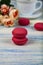 Berry macaroons. white cup and rose