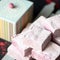 Berry marshmallow airy dessert, fluffy sweetness. Stack of pink pastille pieces. Puffy natural paste on blurred