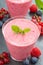 Berry milkshake in glass, top view, vertical