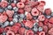 A Berry mix from frozen raspberries and blueberries. A Frozen Berries from freezer.  A sweet background with frozen raspberries