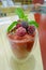 Berry smoothie beverage in a glass on the wooden table