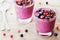 Berry smoothie or milkshake with chocolate for healthy dessert, snack and breakfast on wooden rustic table.