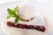 Berry strudel cake served with ice cream, mint leaf and vanilla sauce. Classical austrian dessert on white plate. Sweet