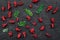 Berry theme. Red currant, cherry and leaves on black table background top view