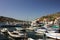 Berth with boats. Mountains.