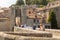 BESALU, SPAIN - AUGUST 2, 2019: Tourists on a stone bridge in front of the entrance to Besalu.