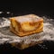 Besquit, cake on a black background, sprinkled with powdered sugar, dark and light layer of beckett on a black background, copy