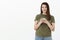 Best app ever. Portrait of good-looking pleased and upbeat young friendly woman with brown hair in olive t-shirt smiling