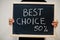 Best choice 50% written on blackboard. Black friday concept. Boy hold board