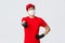 Best delivery service. Enthusiastic asian courier worker in medical mask and gloves, red uniform, show thumbs-up and