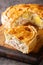 Best ever picnic pie and a New Zealand favourite Bacon and Egg Pie closeup on the wooden board closeup. Vertical