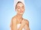 This is the best feeling. a young woman in a towel against a blue background.