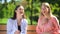 Best female friends smiling spending time on bench park, friendship connection