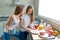 Best friends girls teens breakfast in kitchen