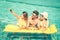 Best friends taking selfie at swimming pool with yellow airbed