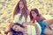 Best friends teen girls together on beach sunset