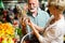 Only the best fruits and vegetables. Beautiful mature couple buying fresh food on market