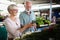 Only the best fruits and vegetables. Beautiful mature couple buying fresh food on market