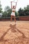 She is the best! Full length of beautiful young woman in sports clothing standing on tennis court. Sporty attractive woman holding
