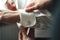 Best-man helping groom to dress. Male hands adjusting shirt sleeves with anchor cufflinks.