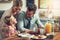 The best moms make pancakes for breakfast. a little boy eating breakfast with his parents.