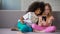 Best multiracial friends having fun on sofa and taking selfie on smartphone