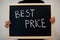 Best price written on blackboard. Black friday concept. Boy hold board