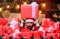 Best prices for winter gifts. Man Santa hat peeking out of pile of gifts. Bearded Santa Claus and many holiday packages