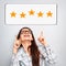 The best rating, evaluation. Business confident happy woman voting the two hands on five yellow star to increase ranking pointing