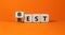 Best rest symbol. Turned wooden cubes and changed the word Rest to Best. Beautiful orange table orange background. Business and