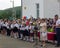 The best students of the school with certificates in their hands and the headmaster in the school yard at the opening ceremony of