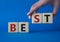 Best symbol. Concept word Best on wooden cubes. Businessman hand. Beautiful blue background. Business and Best concept. Copy space