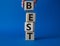 Best symbol. Concept word Best on wooden cubes. Businessman hand. Beautiful blue background. Business and Best concept. Copy space