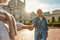 The best wife ever! Beautiful senior couple holding hands and smiling while dancing outdoors on a sunny day