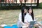 Bestie Happy cute lovely beautiful young girl high school college student enjoy free time read a book at school on grass lawn