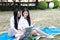 Bestie Happy cute lovely beautiful young girl high school college student enjoy free time read a book at school on grass lawn