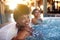 Besties have the best of fun. Portrait of a woman relaxing in a jacuzzi with her friend blurred in the background.