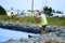 Bethany Beach, Delaware, U.S.A - September 2, 2019 - A man fishing by the rocks by Indian River Inlet