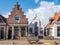 Bethel church and house with stepped gable in old town of Workum, Friesland, Netherlands