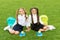 Better ingredients better diet. Happy girls sit on green grass. School break. Snack break. Vegetarian diet. Healthy diet