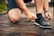 Better make that a double knot. Closeup shot of a sporty young man tying his shoelaces while exercising outdoors.