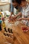 For better pizza. Young couple making pizza together at home. Man in apron, professional cook adding basil on the dough