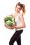 Beuatiful slim girl holding basket of fresh raw green vegetables on white background
