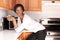 Beutiful black woman in the kitchen smiling